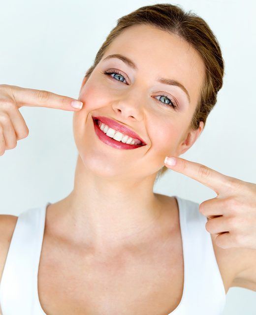 Portrait of beautiful young woman with perfect smile. Isolated on white.
